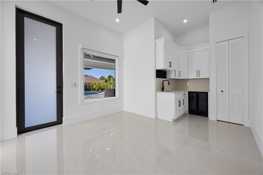 Mother In Law Living room with white cabinets, wine cooler, recessed lighting, and a ceiling fan
