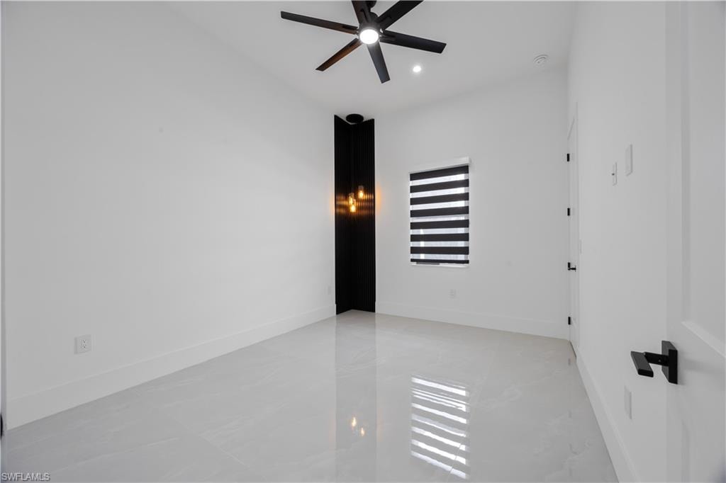 Empty room with a ceiling fan and recessed lighting