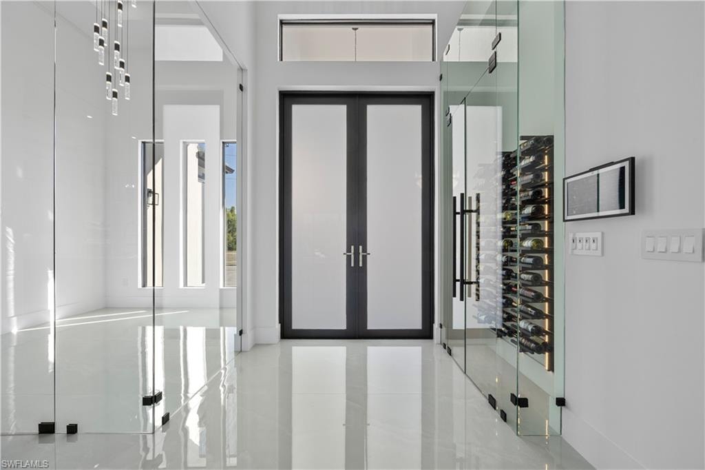 Entrance foyer featuring tile patterned flooring and french doors
