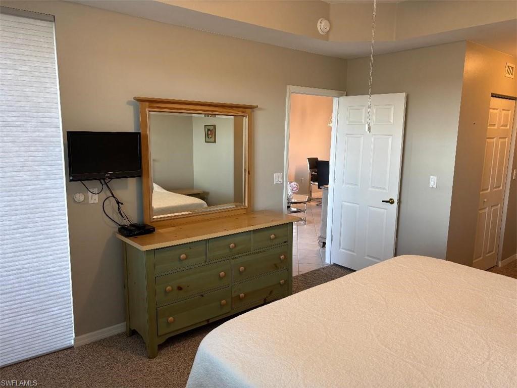 Bedroom with dark carpet.