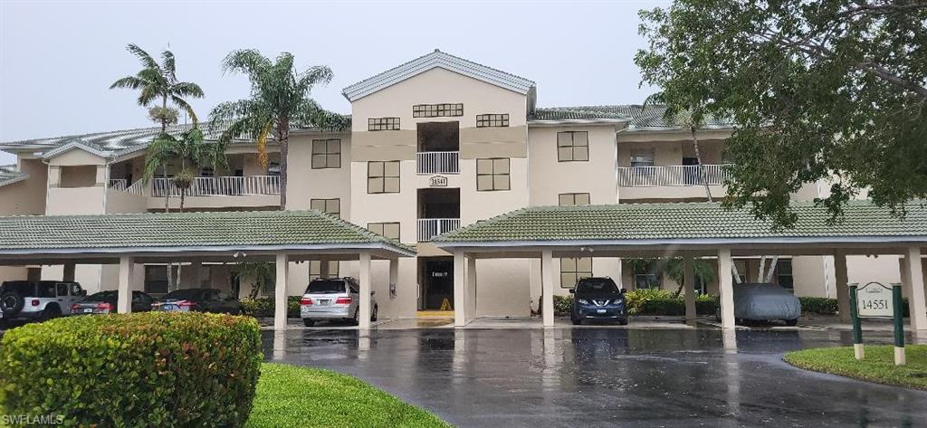View of front of property with assigned carport parking.