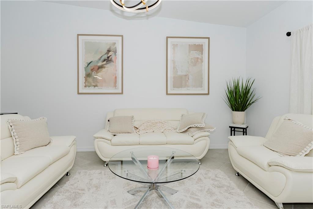 Living area featuring baseboards and tile patterned flooring
