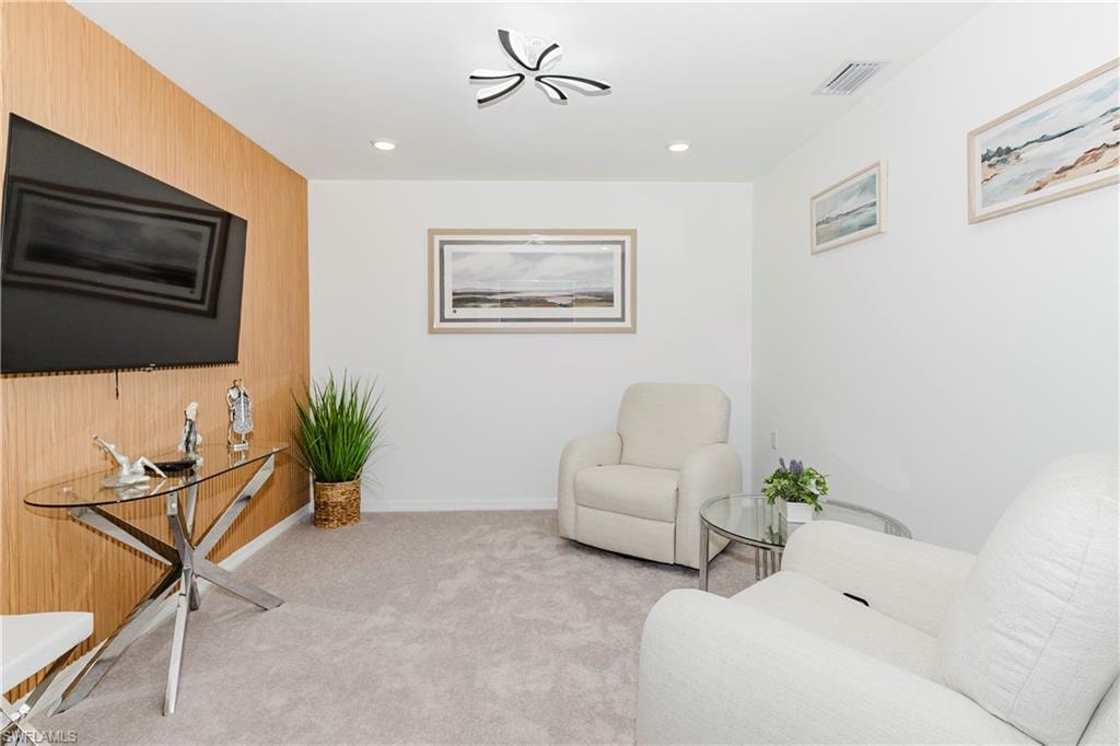 Sitting room with carpet flooring, baseboards, and recessed lighting