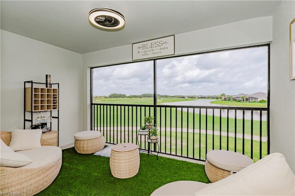 Sunroom / solarium featuring a water view
