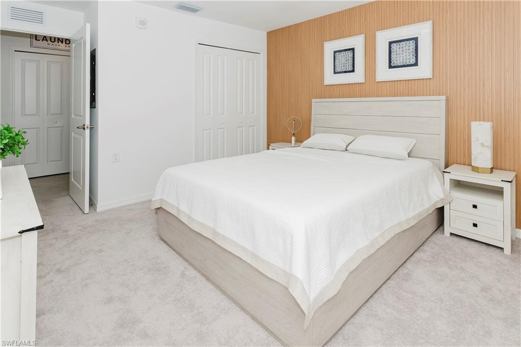 Bedroom featuring carpet and a closet