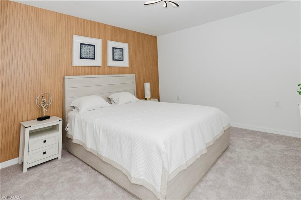 Bedroom with carpet floors and wooden walls