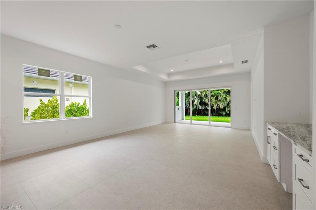 Unfurnished room with concrete flooring and recessed lighting