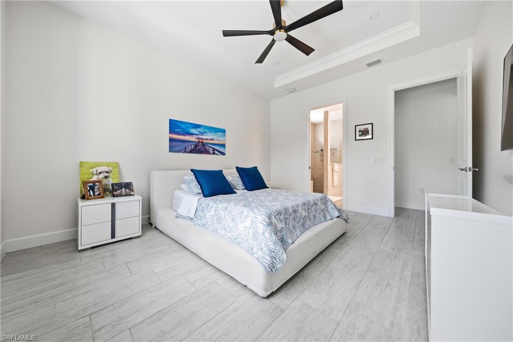 Primary bedroom with new ceiling fan and fresh neutral paint