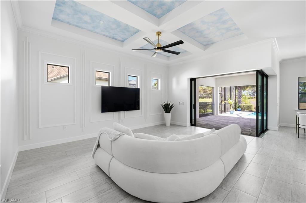 Open-concept living area with custom wood accent wall and new lighting