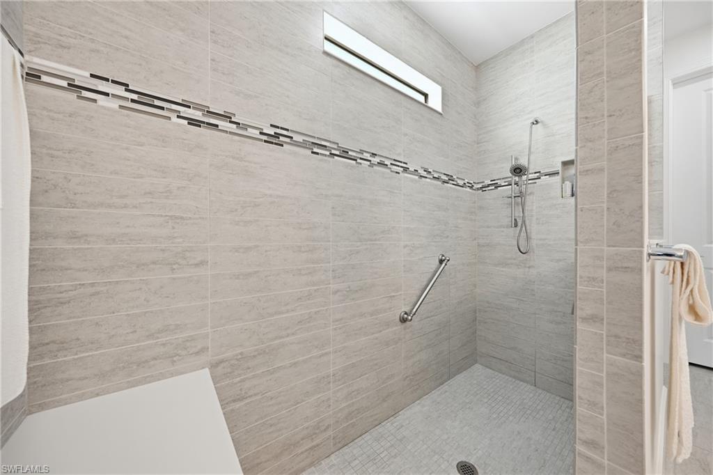 Walk-in shower with clean tile finishes, glass enclosure, and a well-maintained, modern presentation.