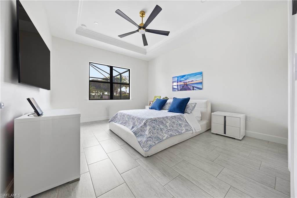 Primary bedroom with new ceiling fan and fresh neutral paint