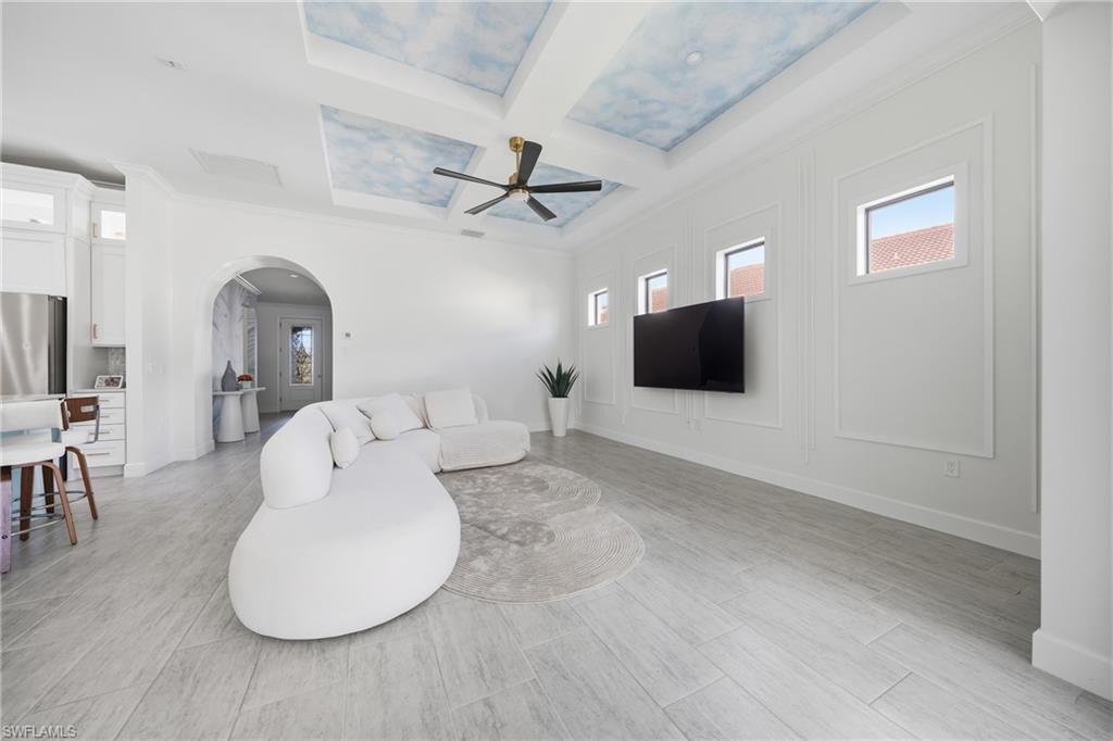 Bright great room with new ceiling fan and freshly painted walls