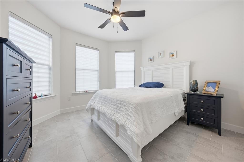 Guest bedroom with new tile flooring and updated lighting