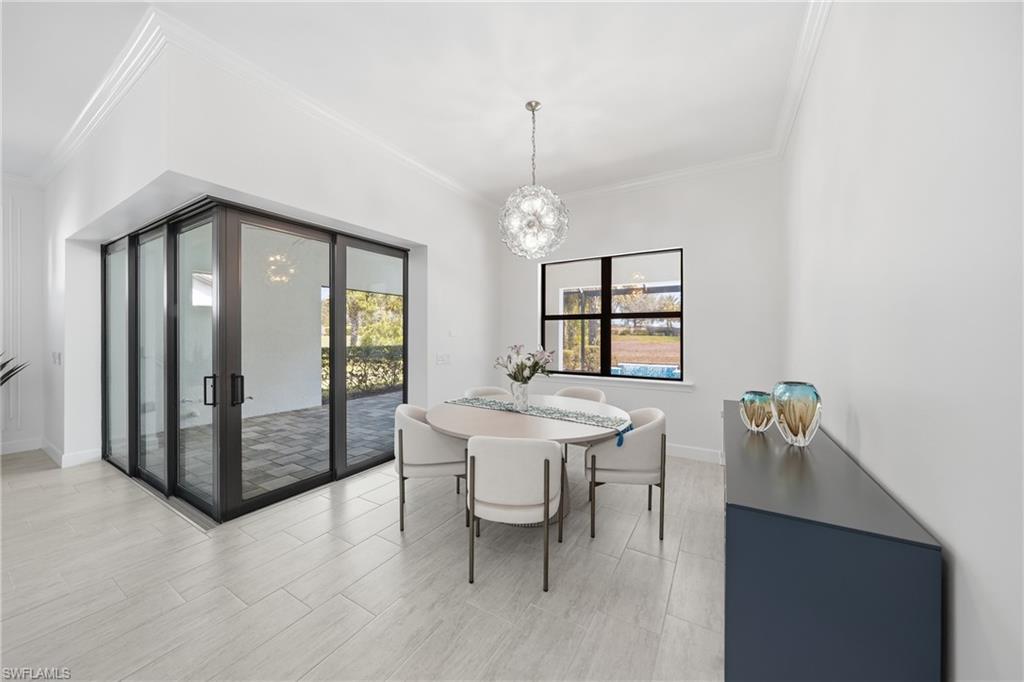Open dining area seamlessly connected to the kitchen and living space, enhanced by fresh paint and updated lighting for a bright, cohesive feel.