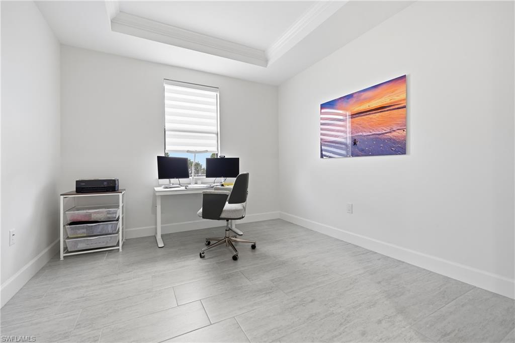 Private office or den featuring fresh interior paint, new lighting, and a modern ceiling fan. Bright, flexible space ideal for a home office, study, or guest room, with clean finishes and a quiet location within the home.