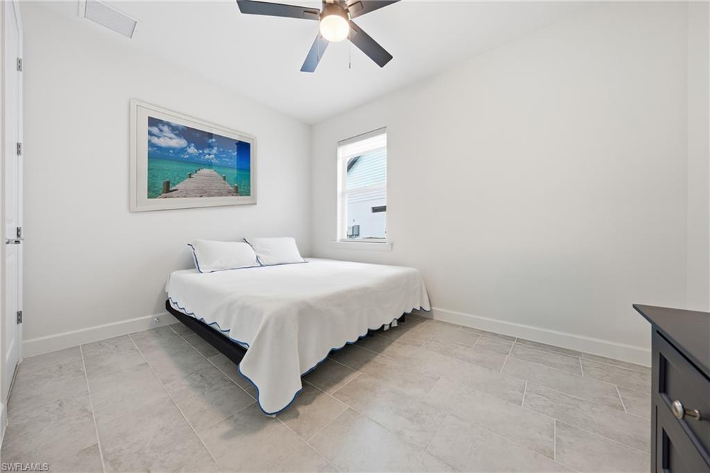 Guest bedroom with new tile flooring and updated lighting