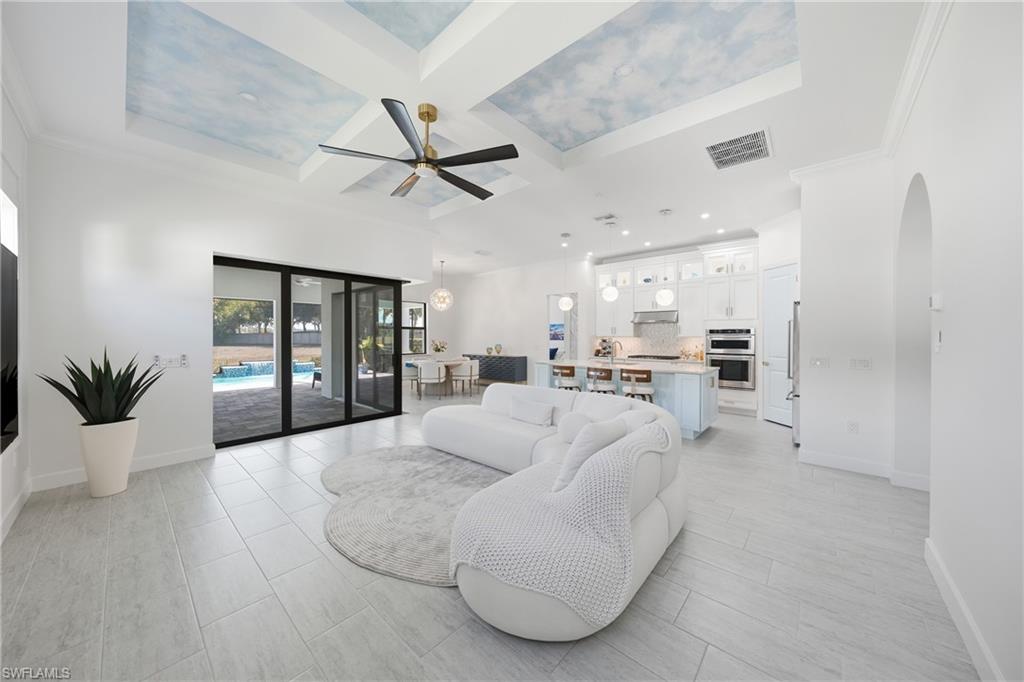 Living room featuring custom painted and textured ceiling for added depth