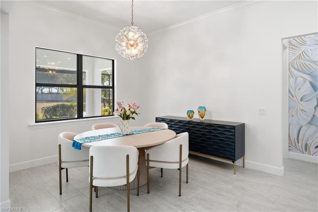 Inviting dining area designed for gathering, featuring updated lighting, fresh paint, and an open connection to the kitchen and main living space.