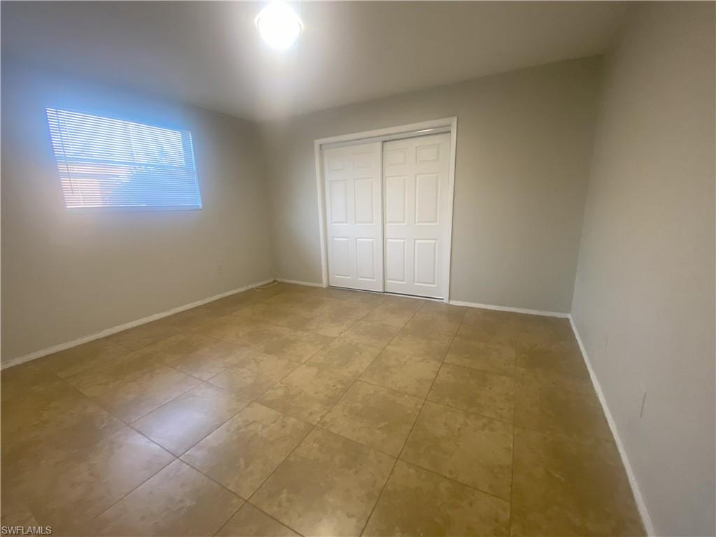 Unfurnished bedroom featuring a closet and tile patterned floors