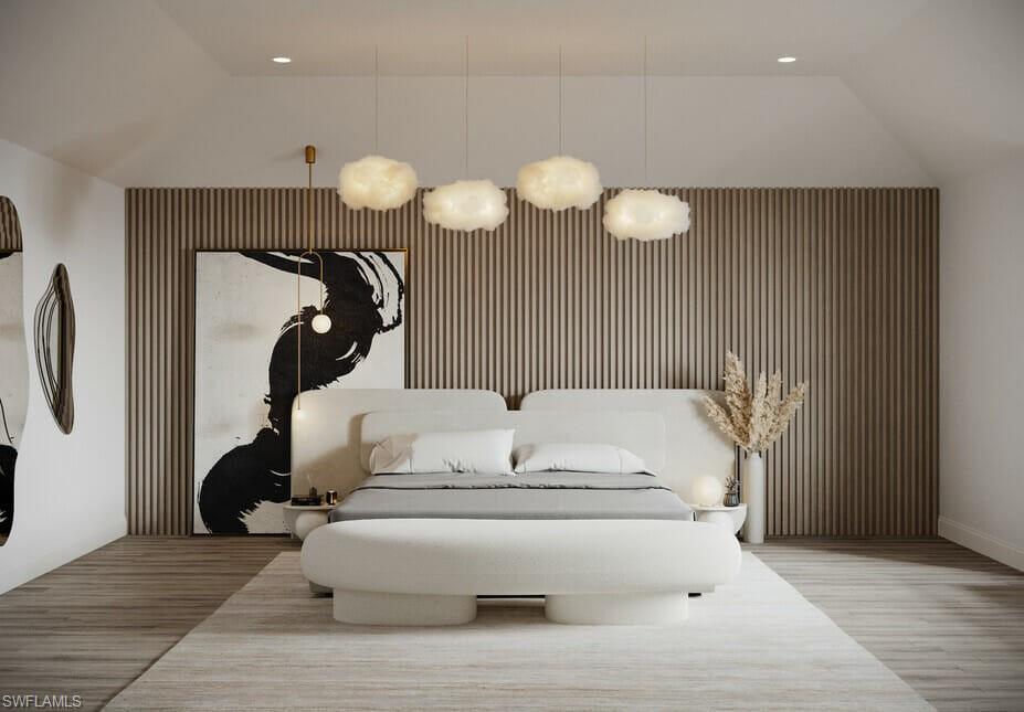 Photos are of a similar home by builder and are for illustrative purposes only. Bedroom featuring an accent wall, recessed lighting, and lofted ceiling.