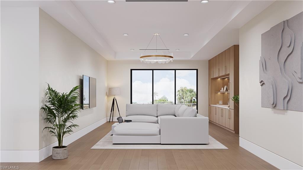 Architectural rendering. Plans and finishes can be customized. Upstairs living area with a tray ceiling, light wood finished floors, recessed lighting, and a desk.