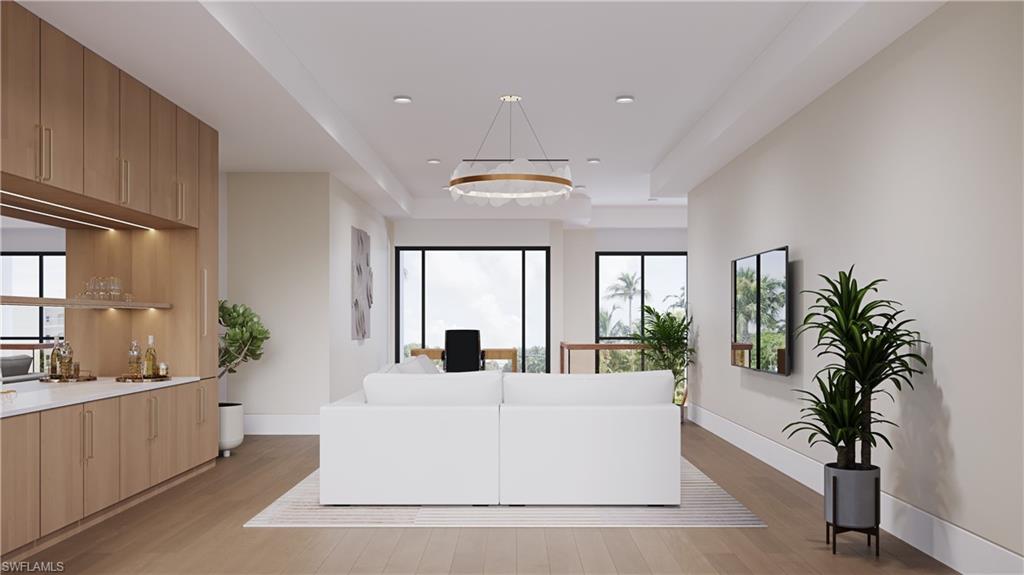 Architectural rendering. Plans and finishes can be customized. Upstairs living area with a tray ceiling, light wood finished floors, recessed lighting, and a desk.