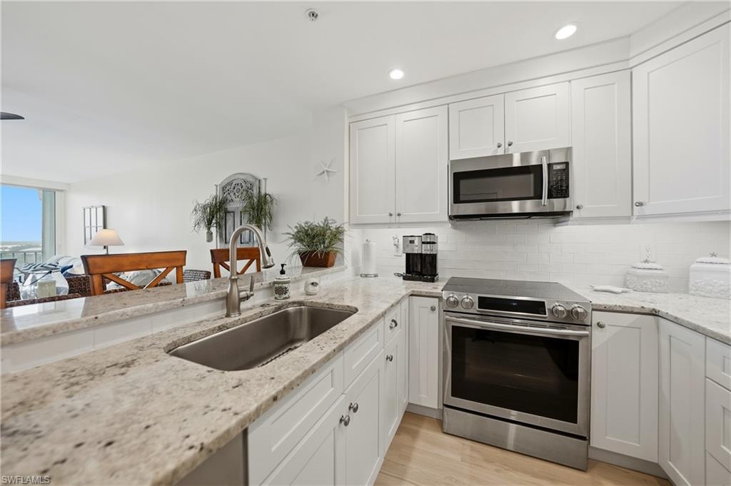 Open Kitchen with Wood Cabinets, Under Cabinet Lighting, Breakfast Bar and Stainless Appliances, Pantry, Tile Flooring