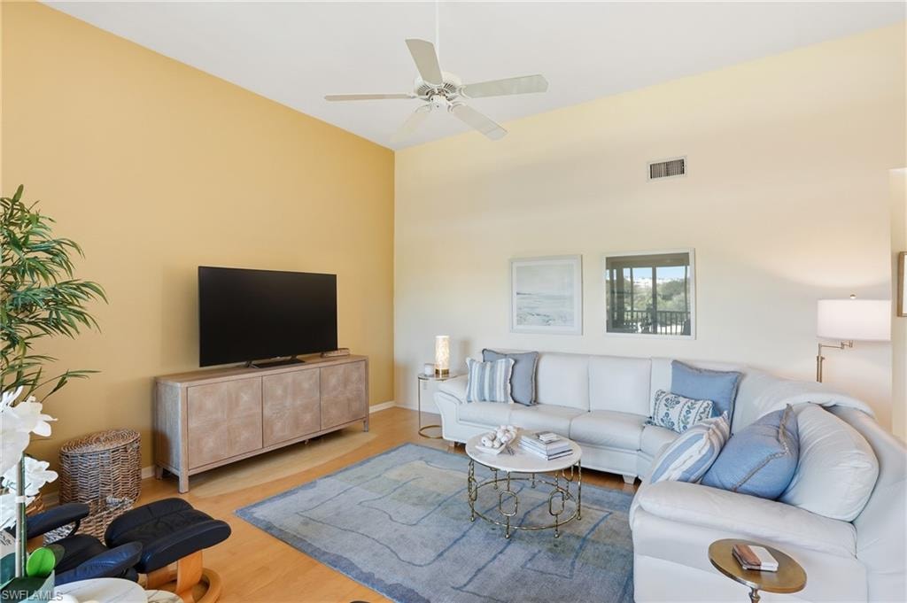 Living room featuring wood finished floors and a ceiling fan