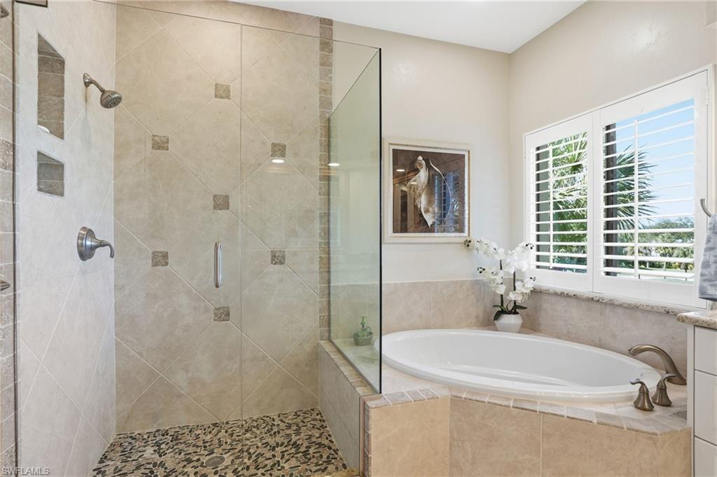 Bathroom featuring a bath and a stall shower