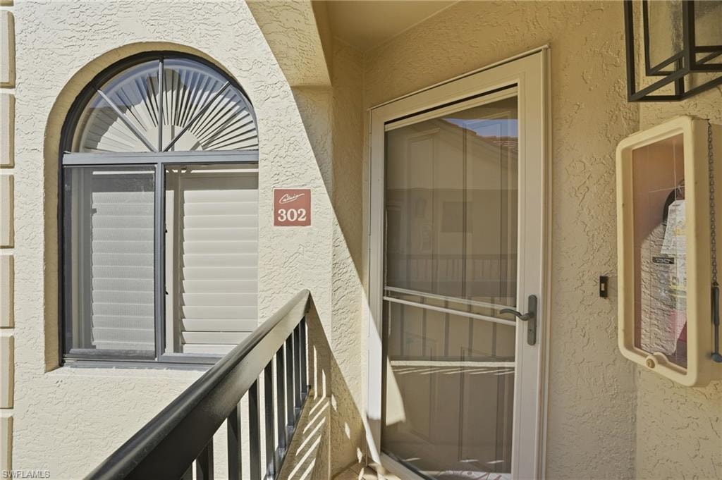 Entrance to property with stucco siding