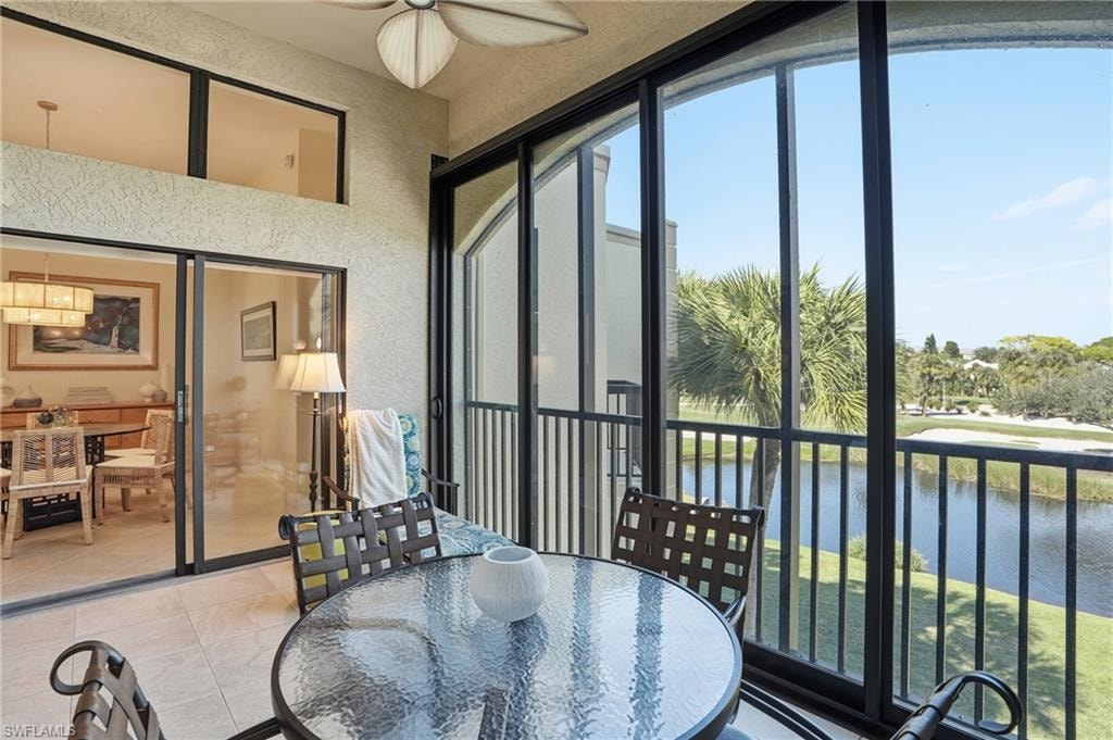 Sunroom featuring a water view