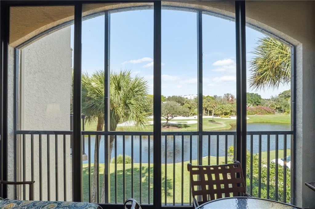 Sunroom / solarium featuring a water view and healthy amount of natural light