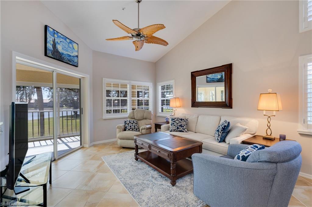 Living area featuring volume ceiling and plantation shutters