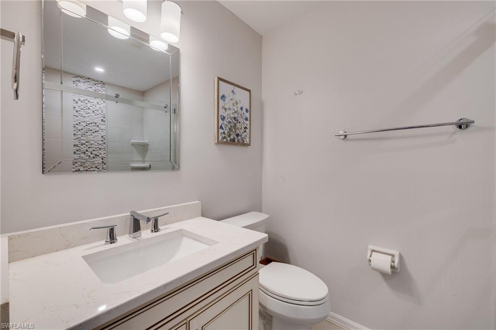 Bathroom with new tiled shower, cabinetry and countertops