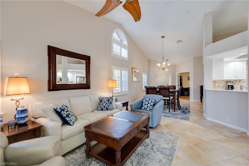Living room with volume ceiling, plantation shutters, additional dining area