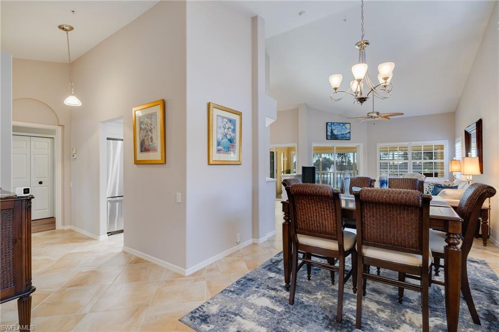 Dining area featuring volume ceiling, open area