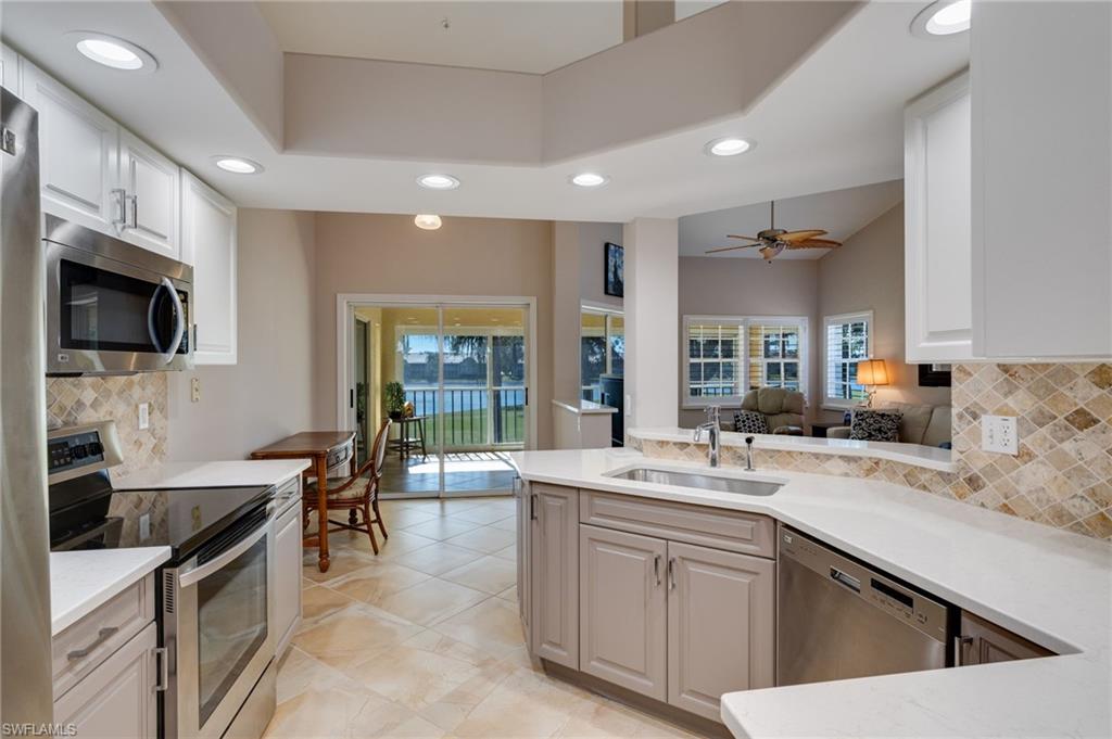 Kitchen to breakfast area to the screened balcony to golf course and lake!