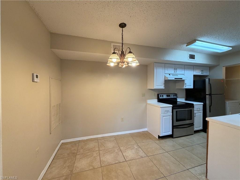 Kitchen featuring white cabinets, light countertops, stainless steel electric range oven, a chandelier, and a textured ceiling