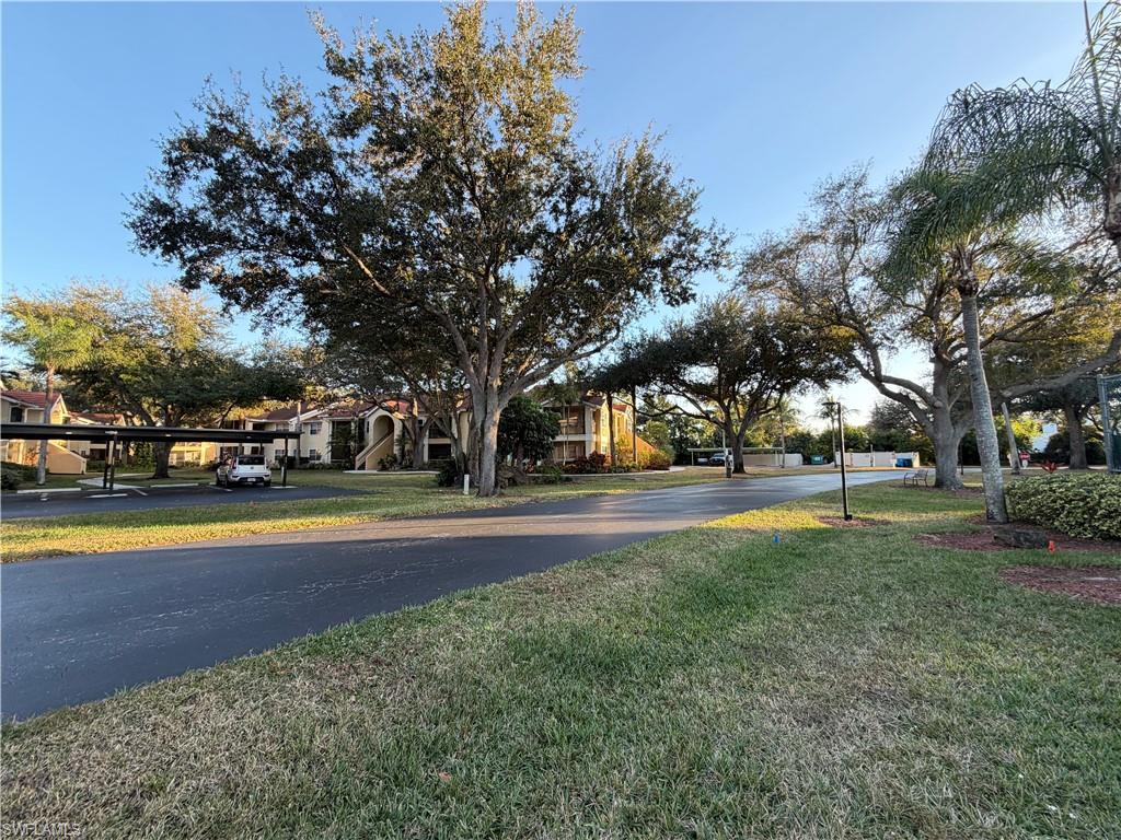 View of asphalt road featuring a residential view