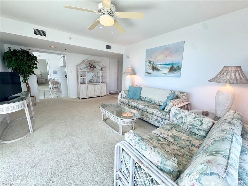 Living room with carpet floors and a ceiling fan
