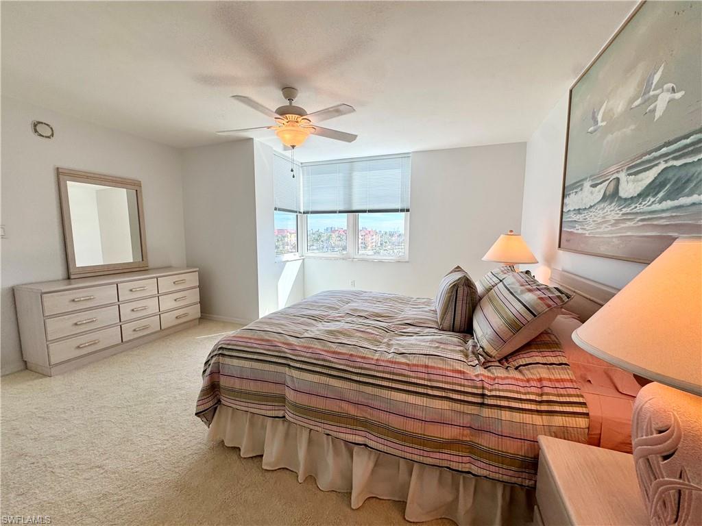 Bedroom with light carpet and ceiling fan