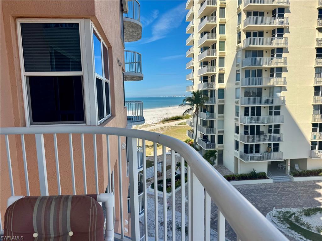 Balcony featuring view of beach