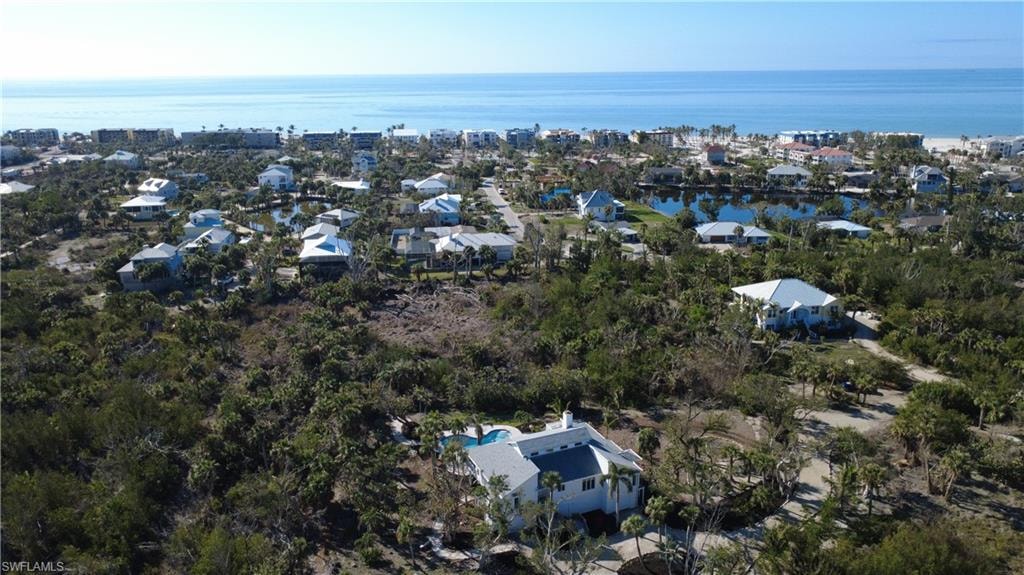 Aerial perspective of suburban area featuring a large body of water