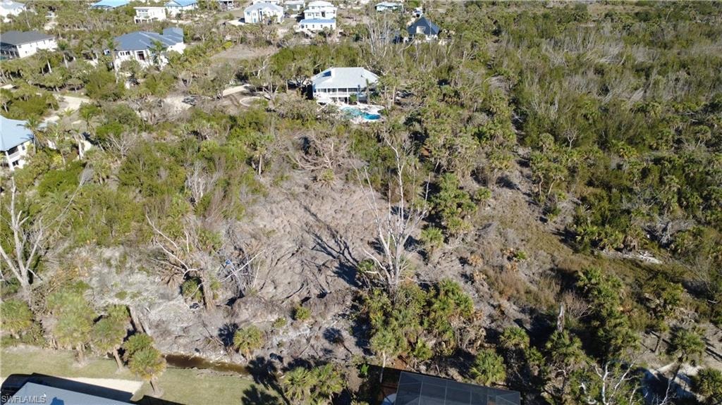 Aerial view of property's location featuring nearby suburban area