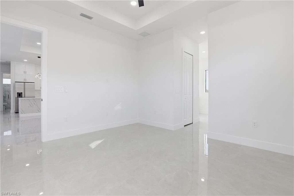 Spare room with recessed lighting and a tray ceiling