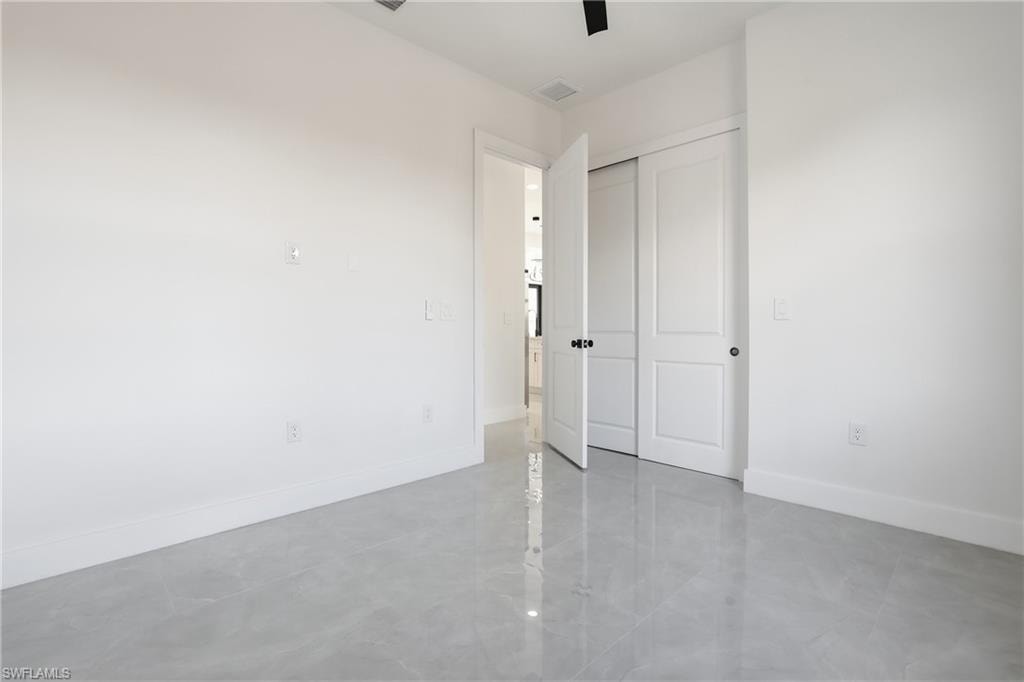 Unfurnished bedroom featuring a closet and a ceiling fan