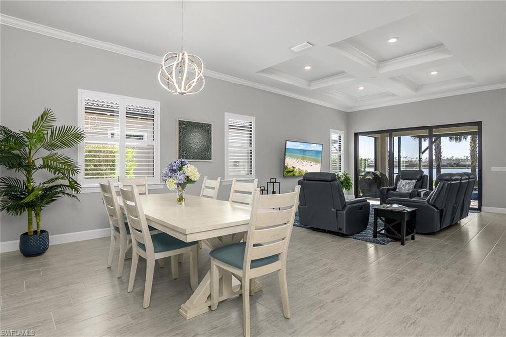 Open floor plan with lots of natural light. Note the plantation shutters, tray ceiling, and crown molding.