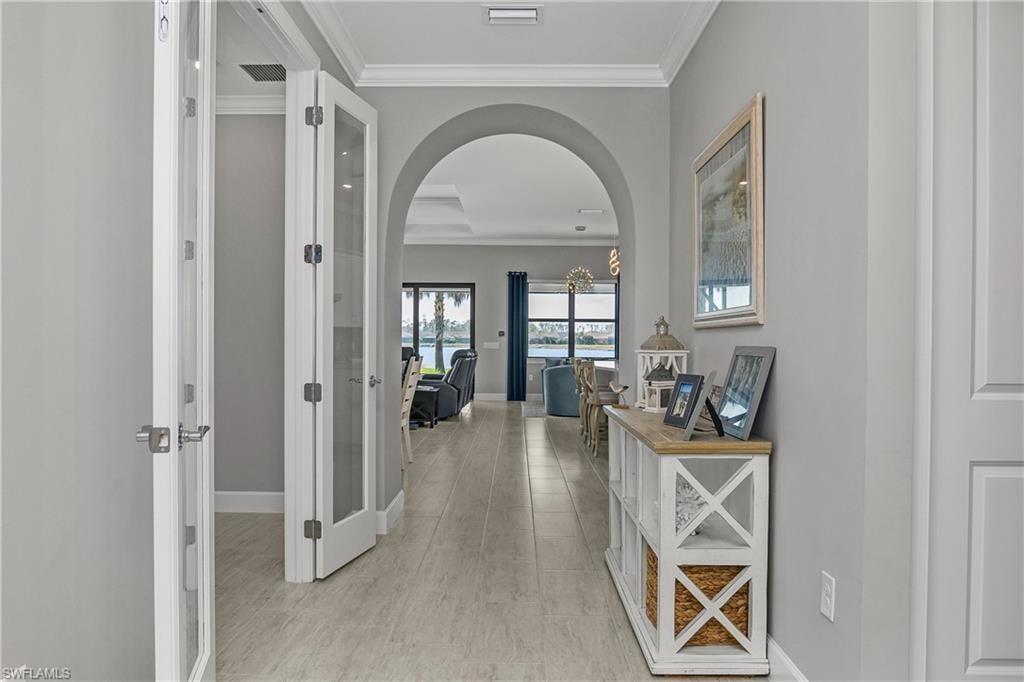 Welcoming foyer with timeless tile throughout the home and crown molding adding a more custom touch to the home.