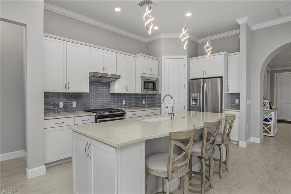 The summerwood floor plan is a favorite -- offering an open floor plan, oversized kitchen island with additional storage, corner pantry, glass tile backsplash and quartz countertops.