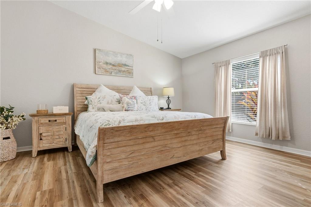 Bedroom featuring light wood-type flooring, a ceiling fan, and vaulted ceiling